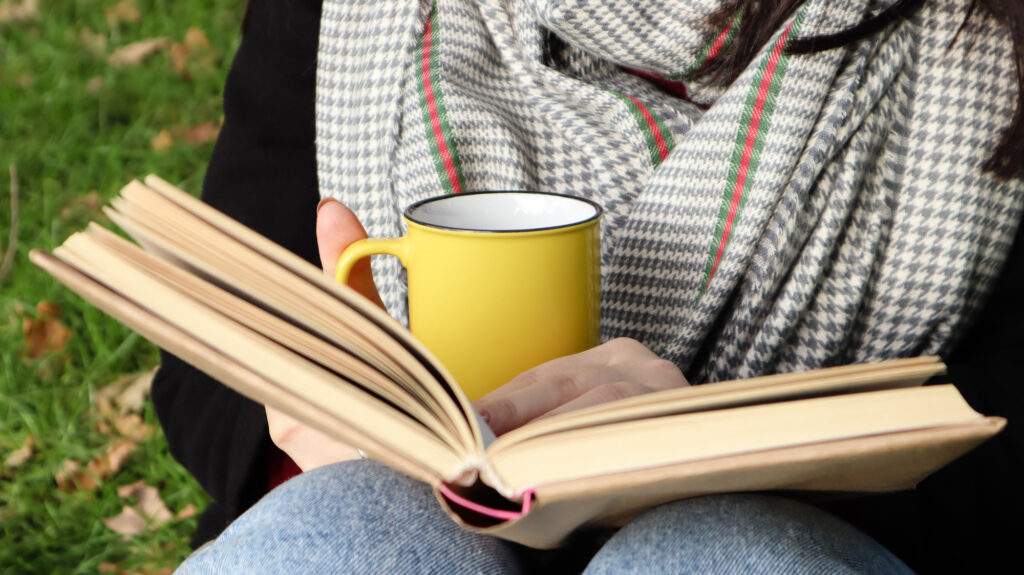 open book with yellow coffee cup